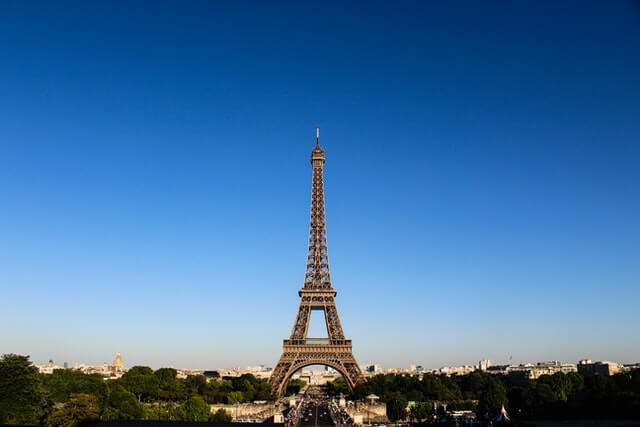 An iron structure shaped in a tower with the sky surrounding it.